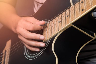 Gitar çalmayı seçme tarzıyla pratik yapan el görüntüsünü kapat 