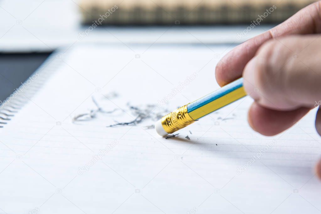 pencil eraser in hand