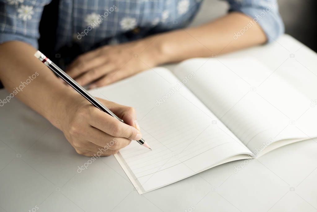 pencil write on notebook