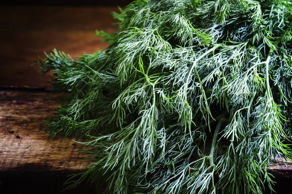 Fresh dill on an old birch board — Stock Photo, Image