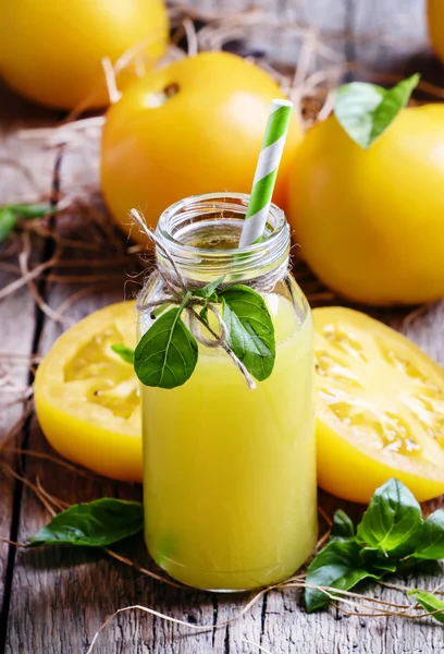 Freshly squeezed juice of yellow tomatoes with basil