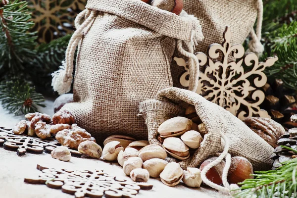 Walnuts, hazelnuts and pistachios in a canvas bags — ストック写真