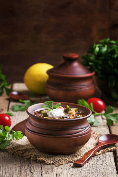 Soup with meat and sausages with vegetables and olives