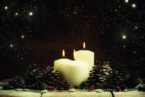 Christmas or New Year's composition with burning white candles — Stock Photo, Image