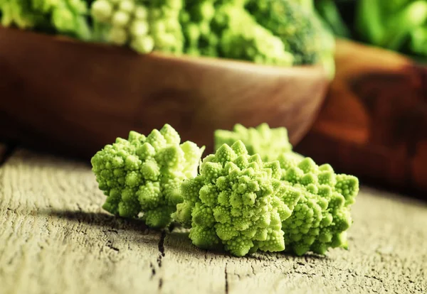 Green cauliflower, old wooden background