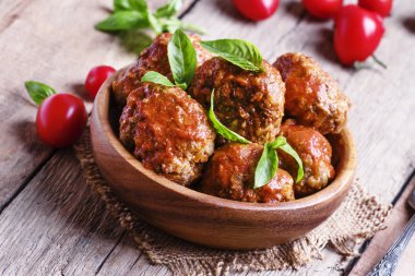 Meatballs with tomato sauce and basil clipart