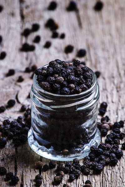 Pea of black pepper in a glass jar — Stock Photo, Image