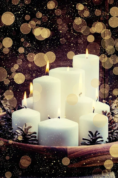 White burning candles with pine cones and cranberries — Stock Photo, Image