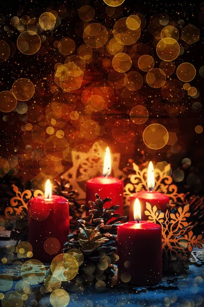 Red burning candles with pine cones and snowflakes — Stock Photo, Image