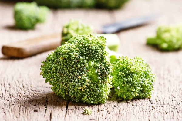 Pieces of broccoli, rustic style — Stock Photo, Image