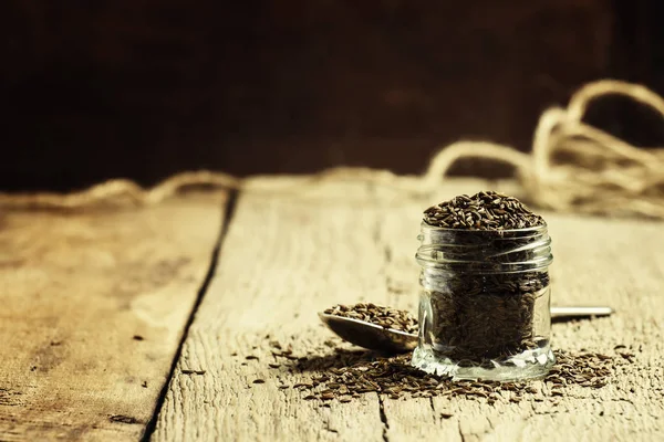 Graines de cumin dans un pot en verre — Photo