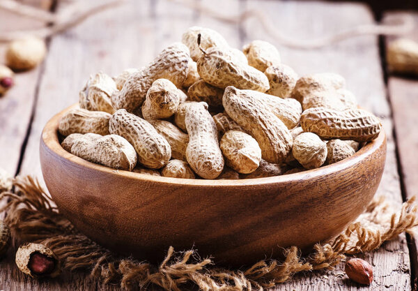 Peanuts in shell, vintage wooden background