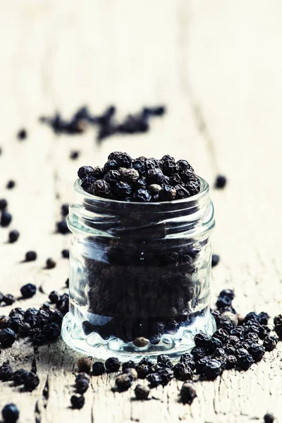 Black pepper, old wooden background — Stock Photo, Image