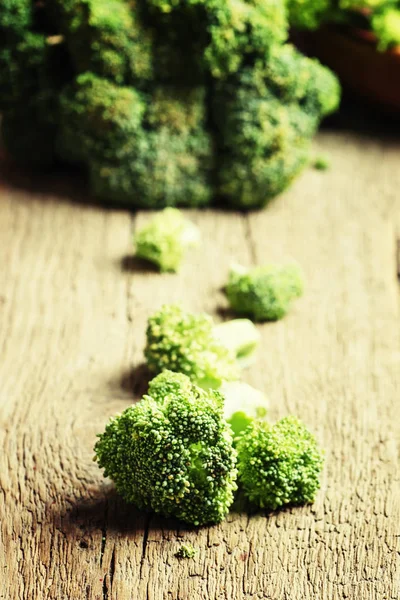 Pieces of broccoli, rustic style — Stock Photo, Image