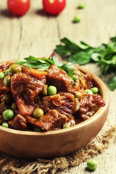 Guisado de carne, ragu de carne com cenouras, cebolas e ervilhas verdes — Fotografia de Stock