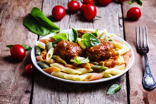 Colorful penne pasta with meatballs in tomato sauce — Stock Photo, Image
