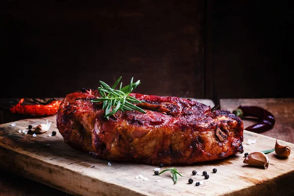 Piece of baked pork with garlic and rosemary — Stock Photo, Image