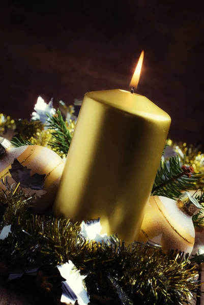 Golden candle with Christmas decorations — Stock Photo, Image