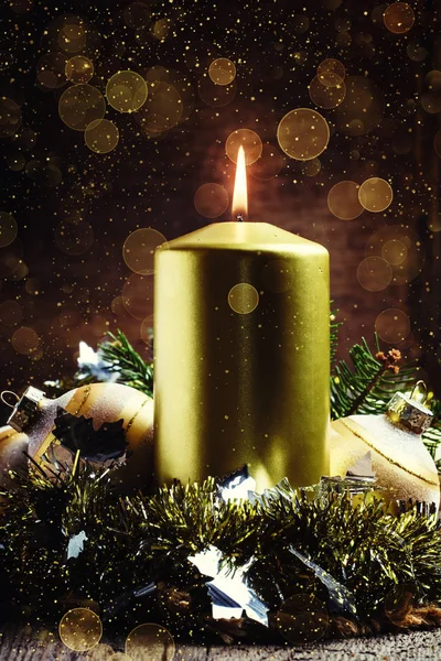 Golden candle with Christmas decorations — Stock Photo, Image