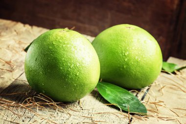 Pomelo fruit on the old wooden table clipart