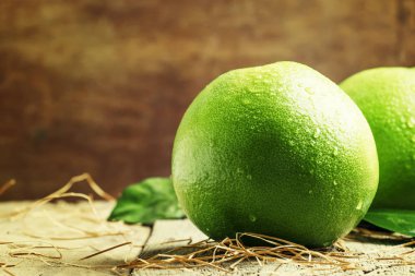 Pomelo fruit on the old wooden table clipart