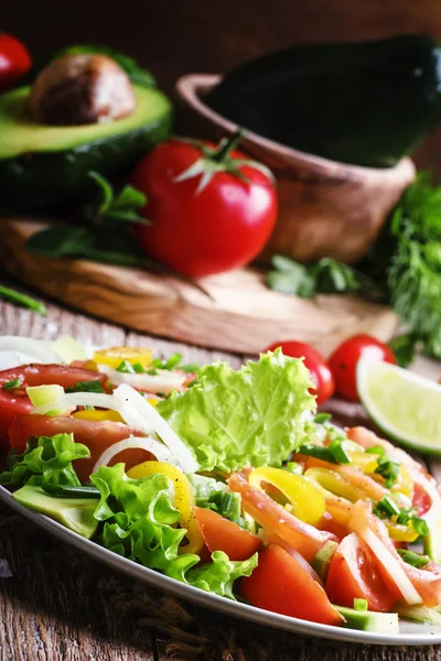 Sallad med avokado, lax, sallad, lök och paprika — Stockfoto