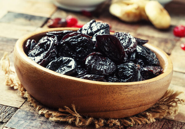 Prunes in wooden bowl
