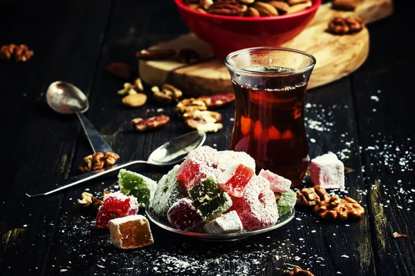 Oriental sweets with nuts and black tea — Stock Photo, Image