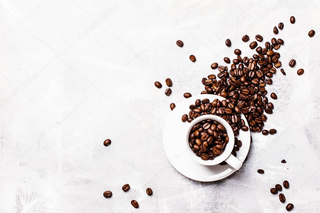 roasted coffee beans in a white cup