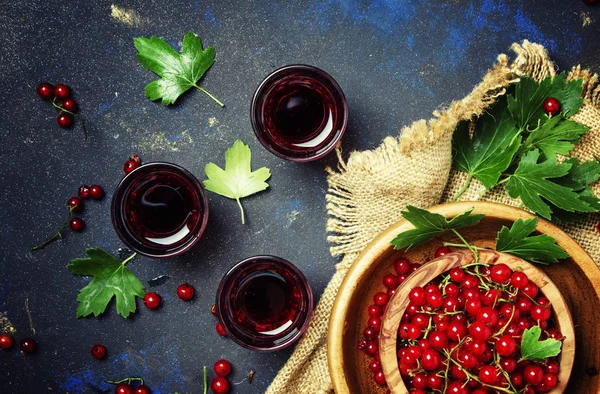 Red currant juice on a dark background
