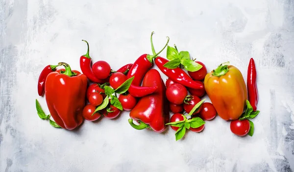 Red vegetables: tomato, bell pepper, chili and green basil — Stock Photo, Image