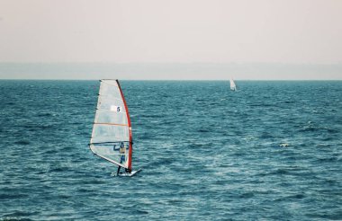 Windsurfer in the sea, autumn windsurfing  clipart