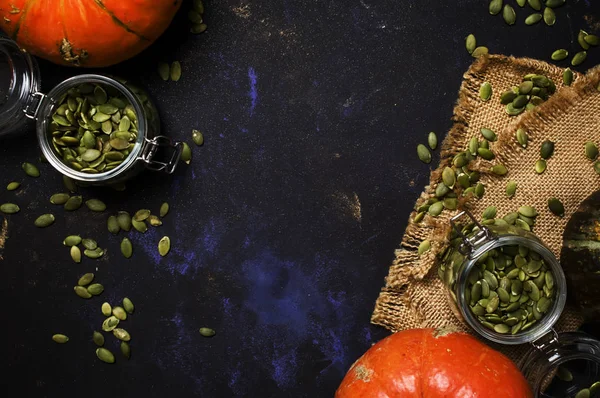 Raw pumpkin seeds in glass jar — Stock Photo, Image