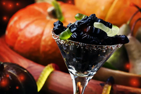 Halloween black candies and pumpkin — Stock Photo, Image