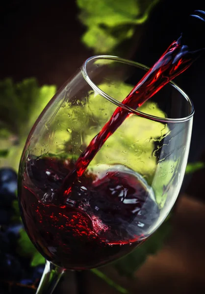 Red wine pouring into a glass — Stock Photo, Image