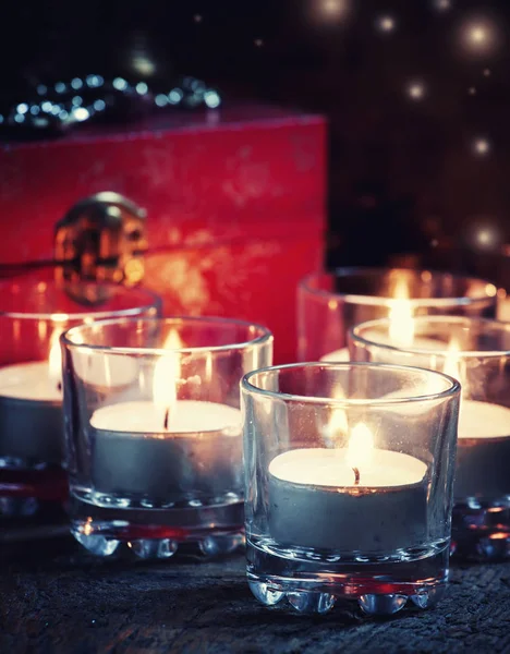 Weihnachtsgeschenkbox und brennende Kerzen. — Stockfoto