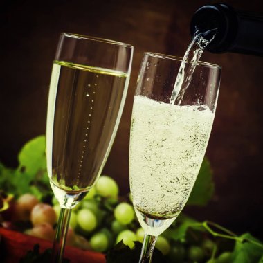 Champagne Pour In Glasses, Grapes With Vine, Vintage Wood Background, Selective Focus clipart