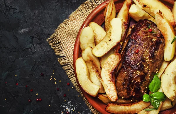 Fried pork tenderloin with quince, dark background, top view — Stock Image Fried Pork Tenderloin Quince Dark Background Top View Royalty Free Stock Images