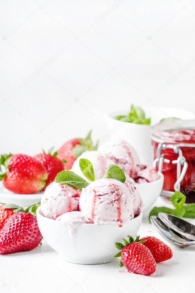 Strawberry ice cream with topping, decorated with mint leaves, white background, high key, selective focus