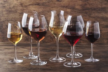 Wine set. Red, white and rose wine in assortment in wineglasses. Wine tasting, vintage wooden background, selective focus, copy space clipart