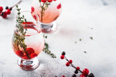 Kırmızı çilek, likör, cin, kekik ve Noel veya Yeni Yıl için votka ile Kış alkollü kokteyl. Tatil masası ayarı