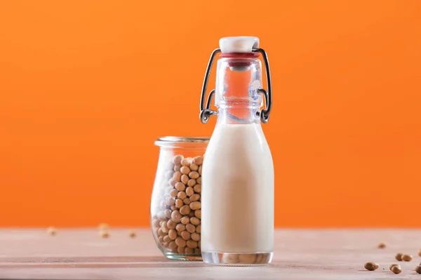 Sojamilch Und Sojabohnen Auf Orangenem Hintergrund Milchfreies Konzept Veganes Getränk — Stockfoto