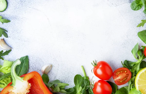 Healthy food background with various green herbs and vegetables. Ingredients for cooking salad. Vegetarian and vegan food concept. Top view, copy space