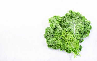 Kale cabbage. Green vegetable leaves, top view on white background, healthy eating, vegetarian food clipart