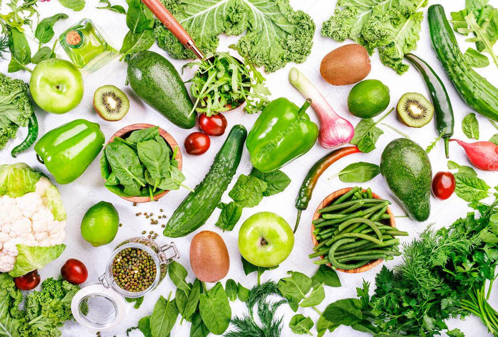 Variety of green vegetables and fruits. Healthy food clean eating: vegetable, seeds, superfood, leaf vegetable, herbs on white background, source of vegetarian proteins and detox diet nutrition