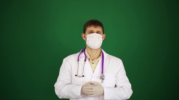 Doctor shows okay. A man doctor on a green background.  The doctor in a gauze dressing shows an OK sign. — Stock Video