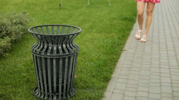 Bir kadın çöp bir sokak çöp kutusuna atar.. — Stok video