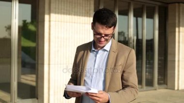 Arka planda Office belgeleri ile erkek iş adamı.
