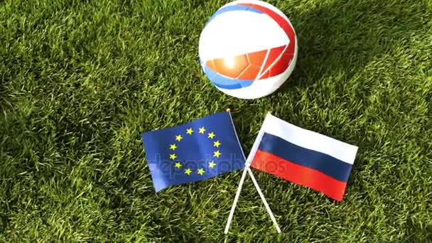 Soccer ball and flags of Russia and the European Union. Football, ball on the grass. — Stock Video