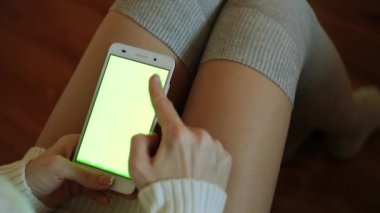 Bir kadın bir smartphone yeşil bir ekran ile tutuyor. Bir akıllı telefon içeriğiniz için yeşil bir ekran ile.